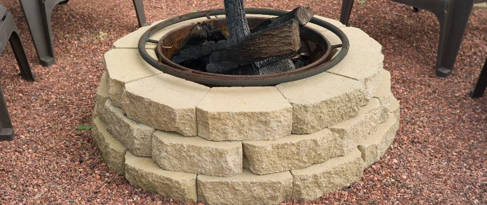 A fire pit in Portland, OR, in a yard with wood.