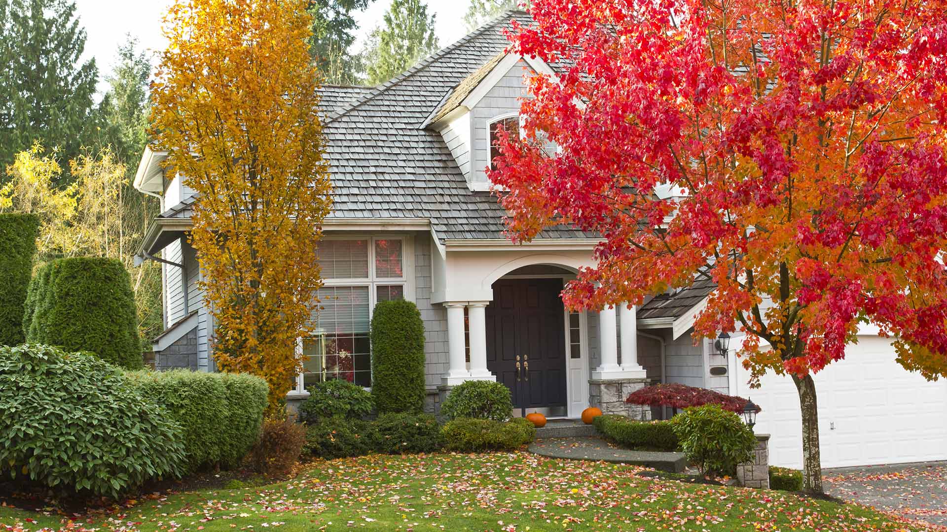 A Gresham, OR home in the fall with leaves and pumpkins.
