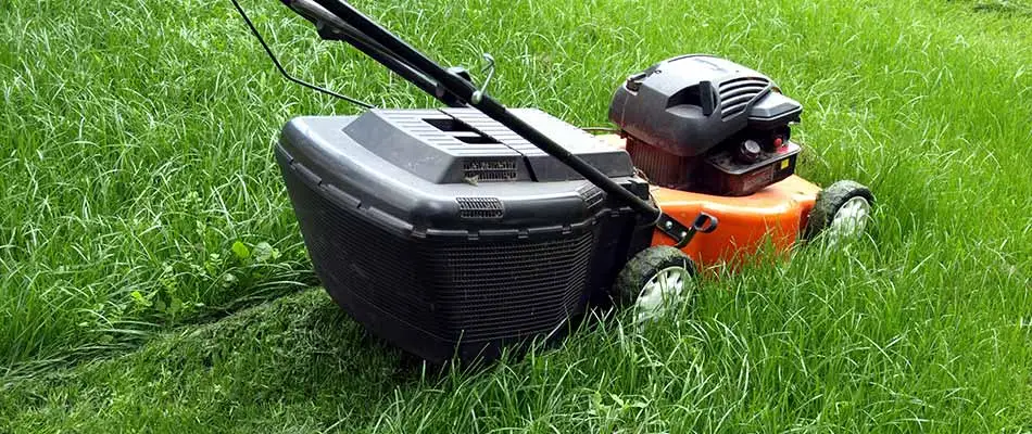 Lawn mower with sharpened blades cutting grass in Happy Valley, OR.