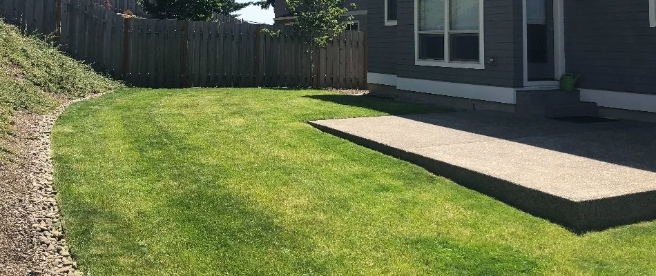 Backyard lawn in Gresham, OR, with a patio.