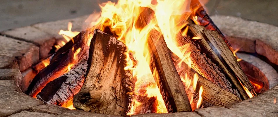 Fire pit in Portland, OR, with burning wood.
