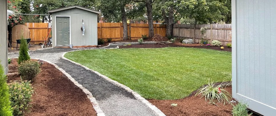 Grass along a pathway and landscape beds in Portland, OR.