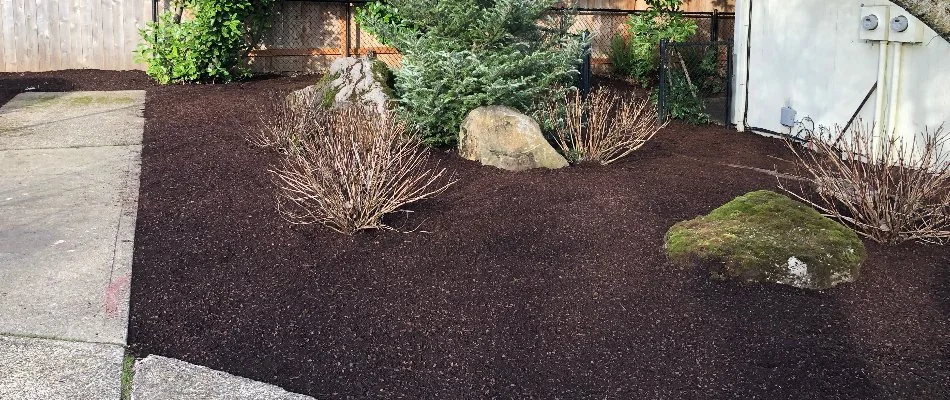 Landscape in Gresham, OR, with fresh mulch, plants, and stones.