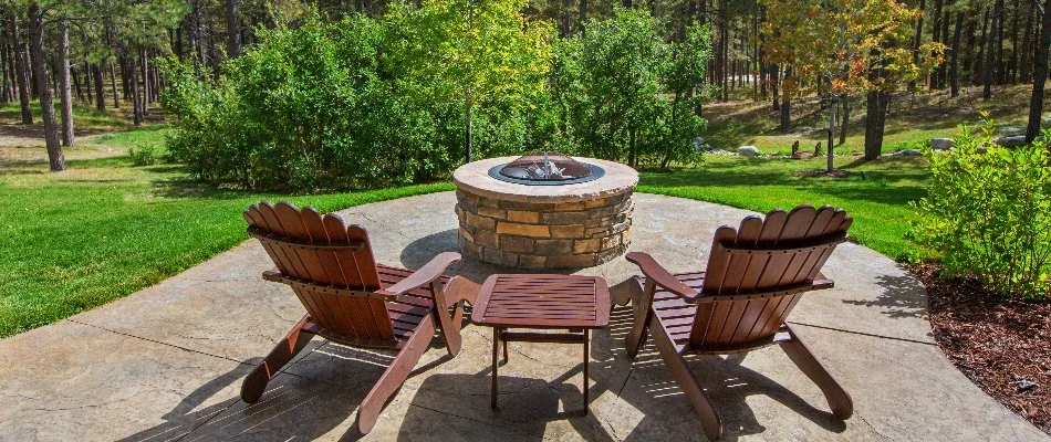 Patio with a fire pit and chairs overlooking trees in Portland, OR.