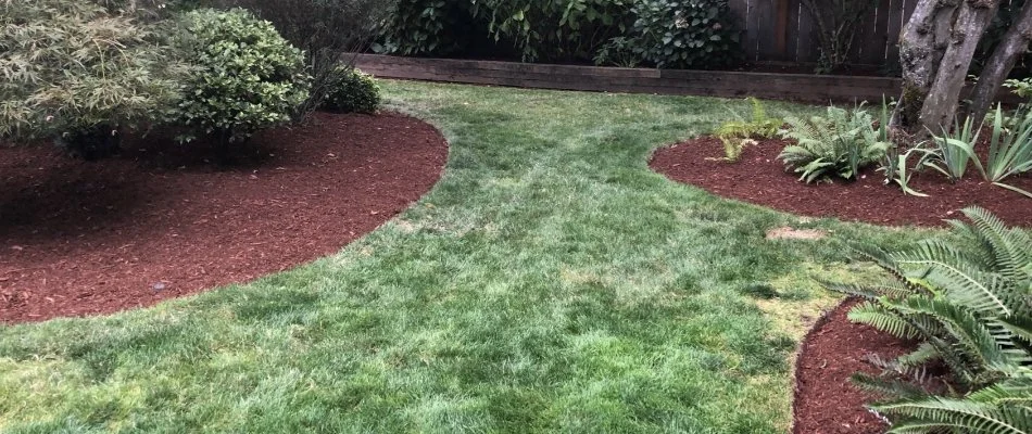 Red mulch installed in landscaping beds in Gresham, OR.