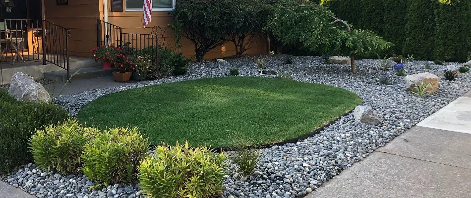 Landscaping rocks around a patch of lawn in Portland, OR.