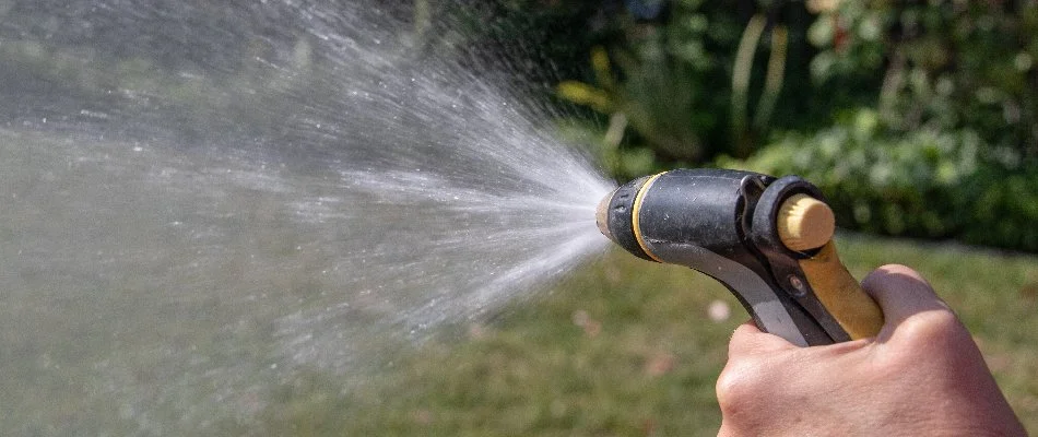 Watering a lawn in Gresham, OR, after fertilization.