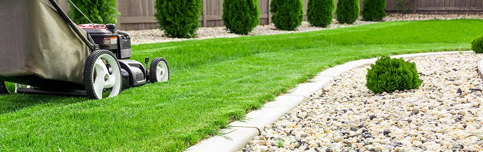 Push mowing a backyard in Troutdale, OR residence.