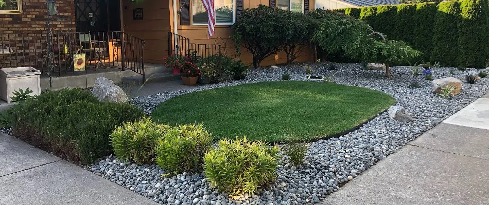 Front landscape in Garden Home-Whitford, OR, with rocks, plants, and turf.