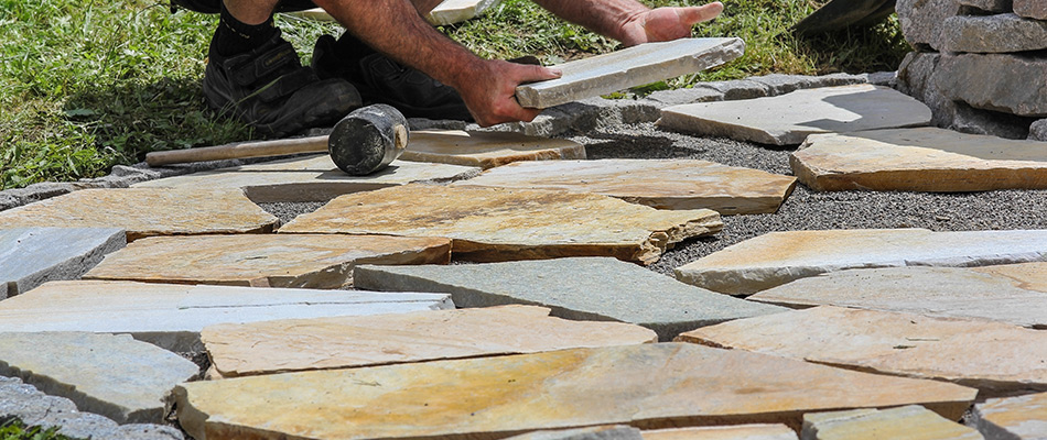 Professional laying down flagstone to built custom patio in Gresham, OR.